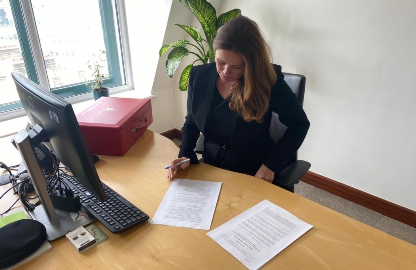 Gillian signing first legislation as Minister 